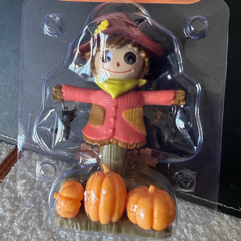 Festive Scarecrow Action Figure with Pumpkins